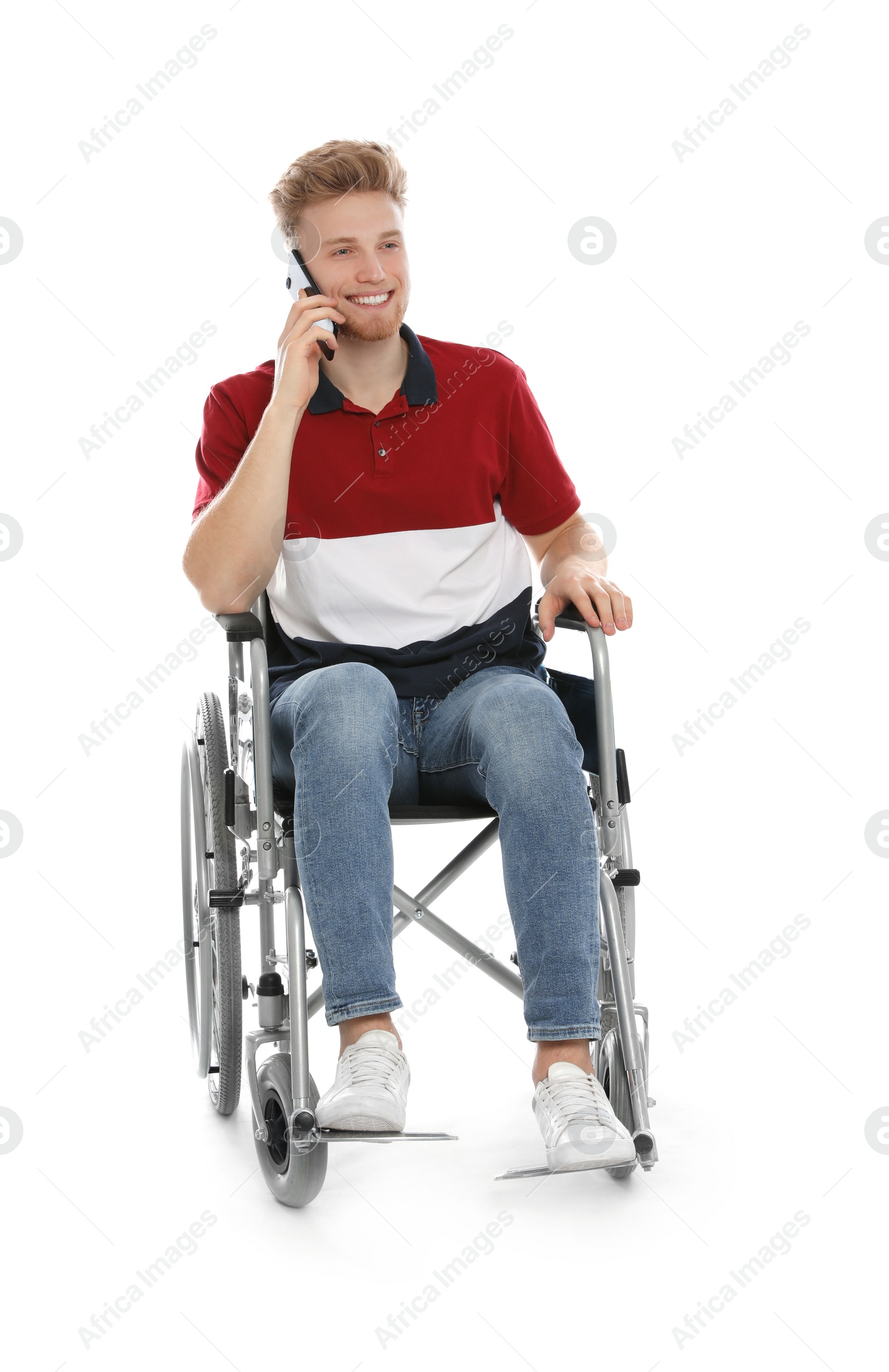 Photo of Young man in wheelchair talking by mobile phone isolated on white