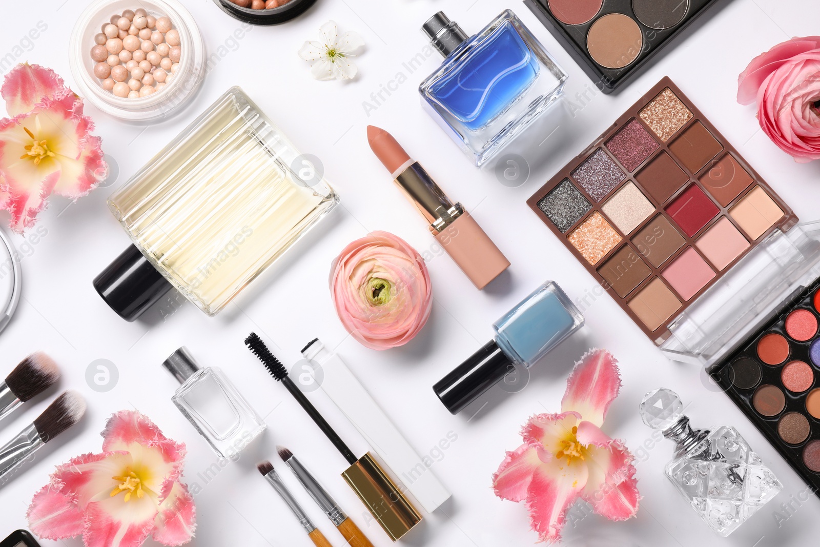 Photo of Flat lay composition with different makeup products and beautiful spring flowers on white background