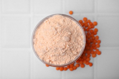 Bowl of lentil flour and seeds on white tiled table, flat lay