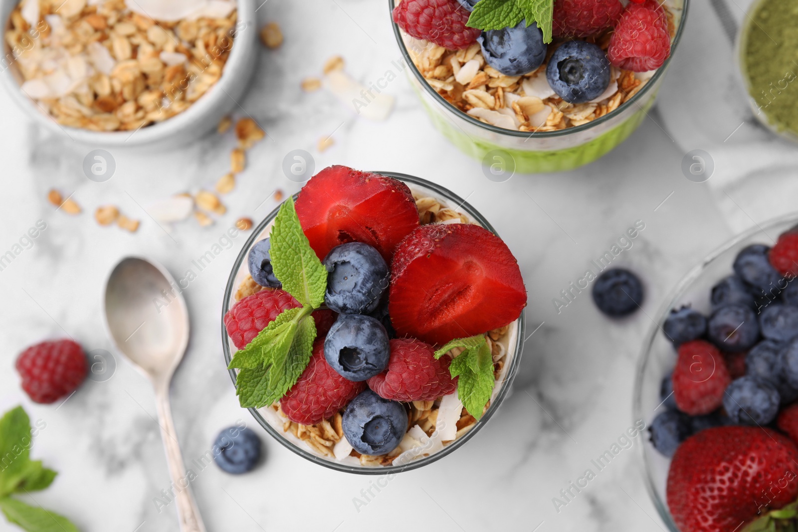 Photo of Tasty oatmeal with smoothie, berries and mint on white marble table, flat lay. Healthy breakfast