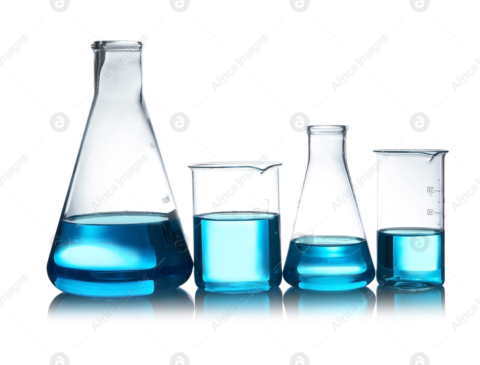 Photo of Laboratory glassware with liquid on table against white background. Chemical analysis