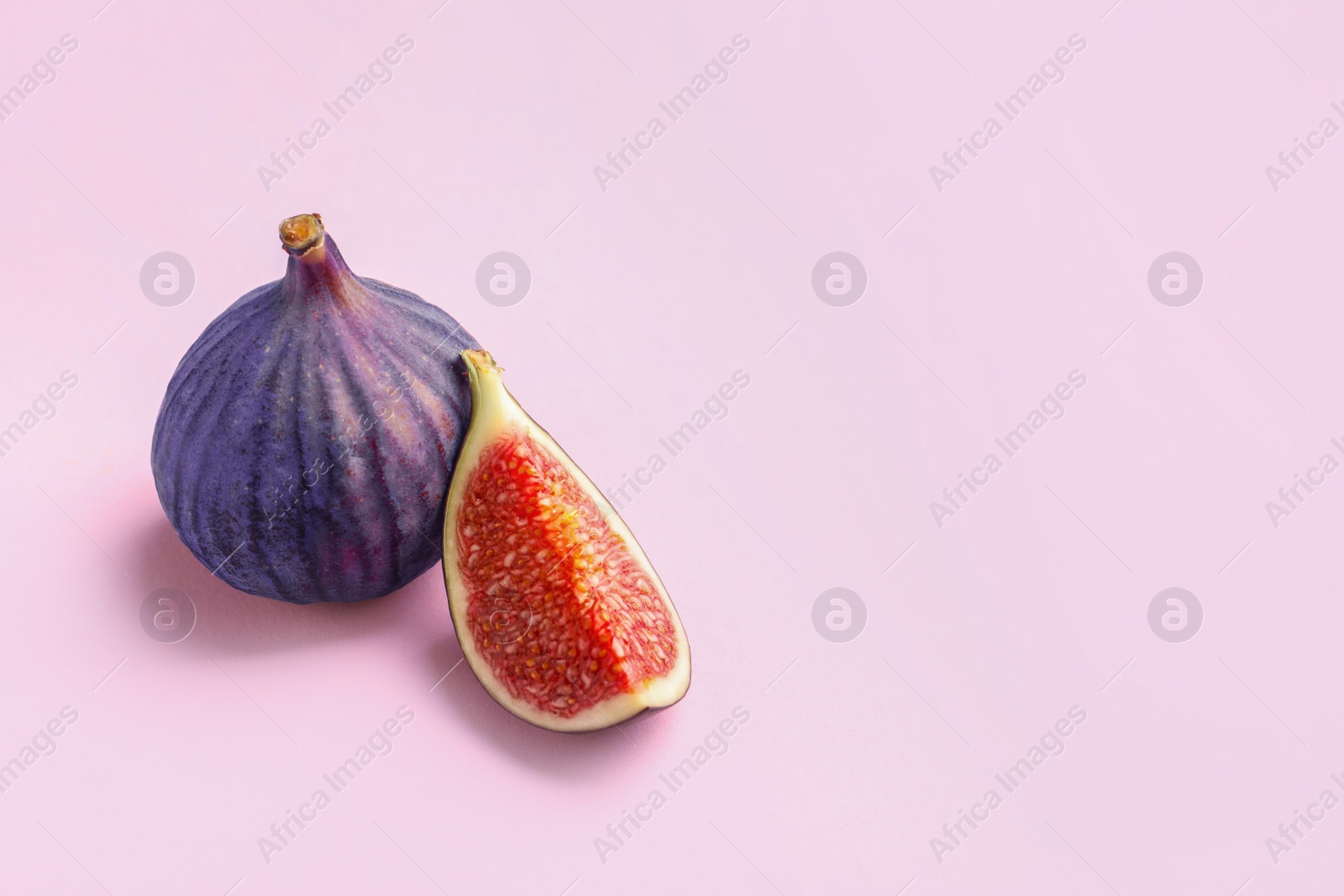 Photo of Fresh ripe figs on color background. Space for text