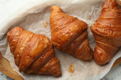 Photo of Tray with tasty croissants on table, top view