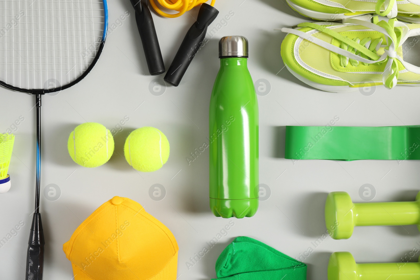 Photo of Different sports equipment on light grey background, flat lay