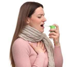 Woman using throat spray on white background