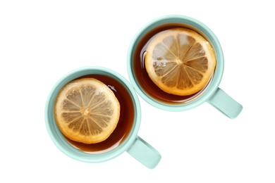 Photo of Cups of tea with lemon on white background, top view