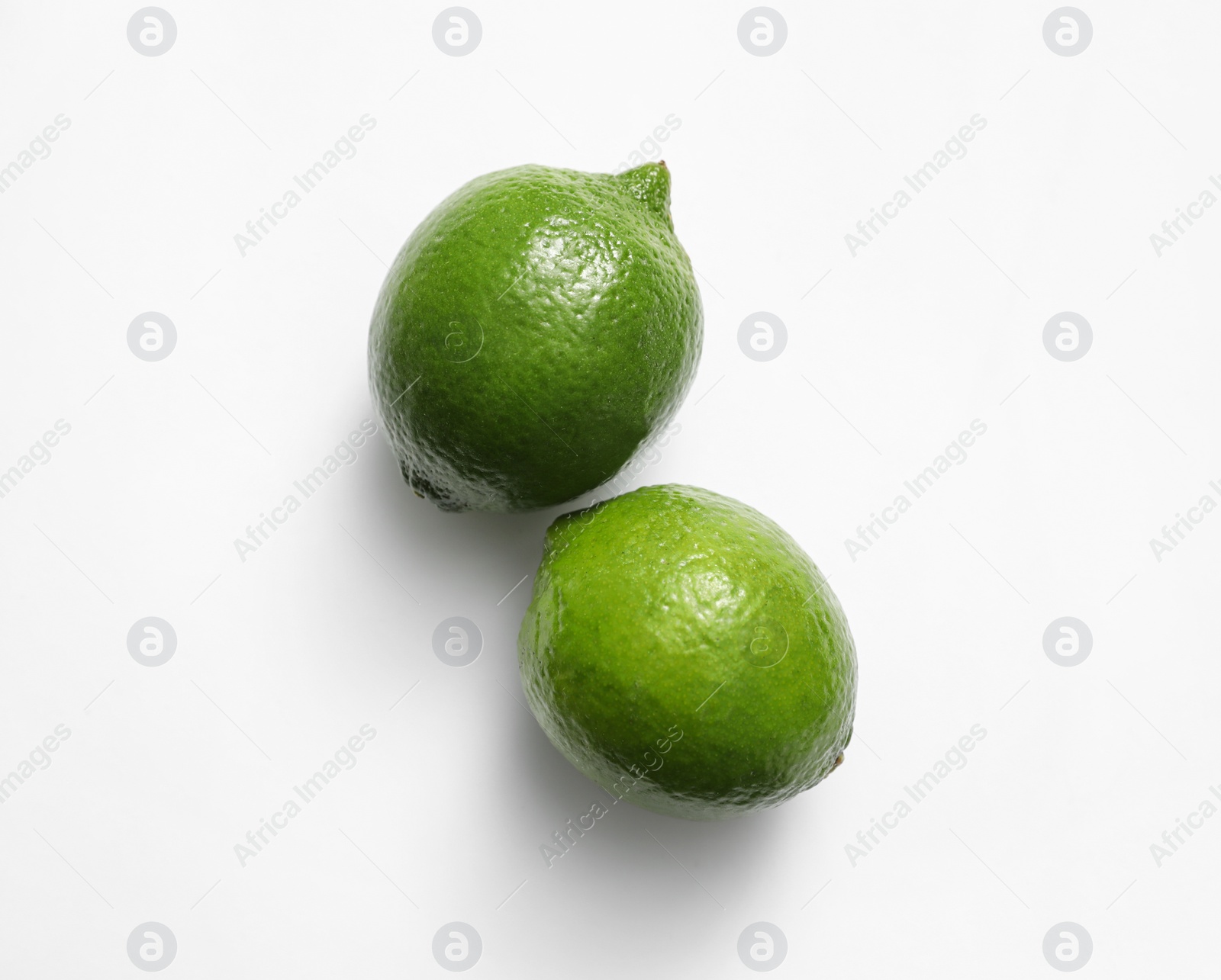 Photo of Fresh juicy limes on white background, top view