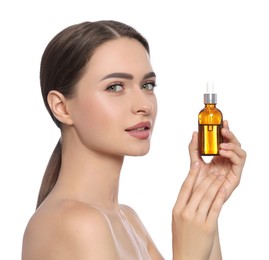 Young woman with bottle of essential oil on white background