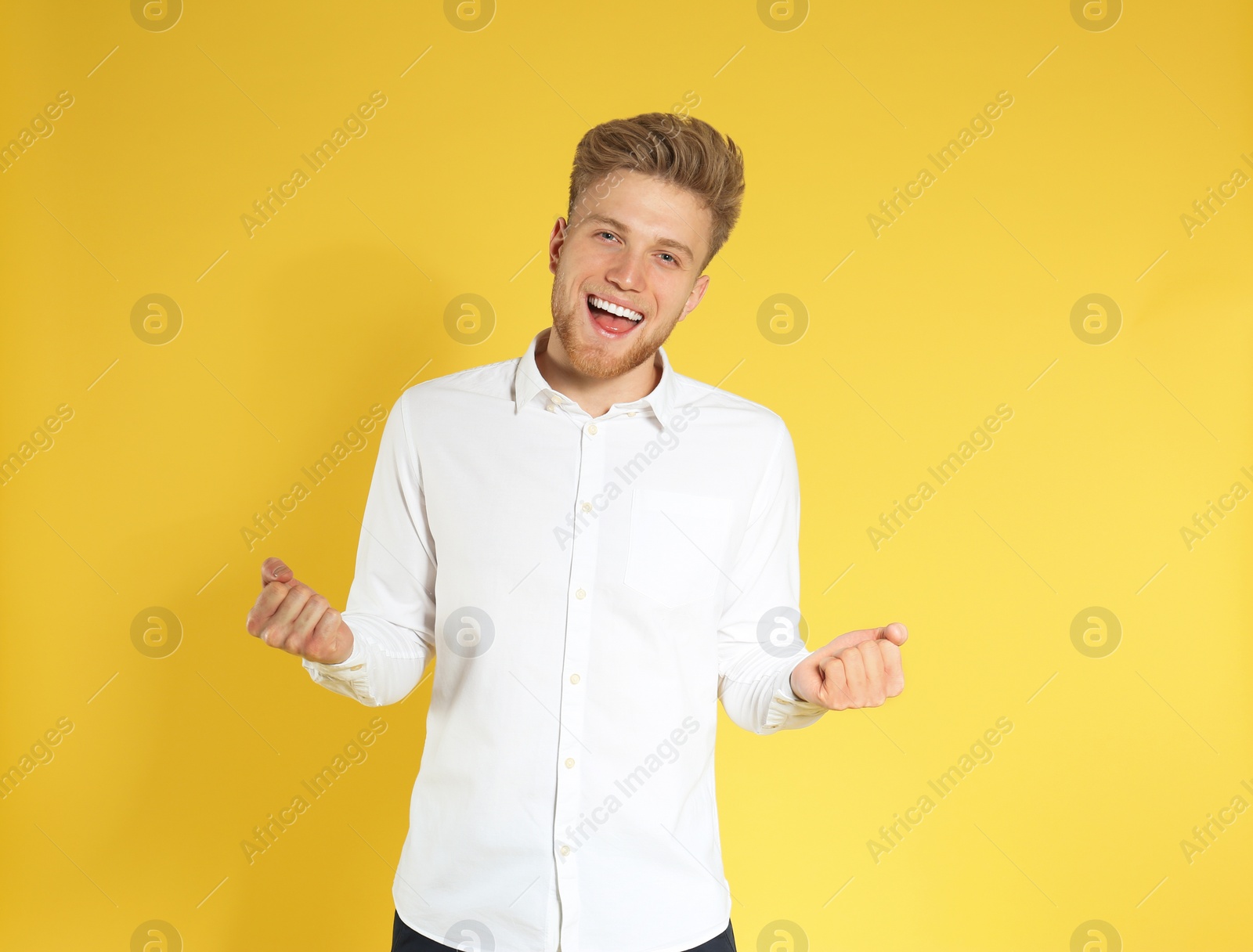 Photo of Portrait of handsome emotional man on color background