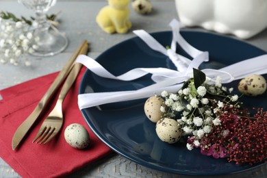 Photo of Festive Easter table setting with beautiful floral decor, closeup