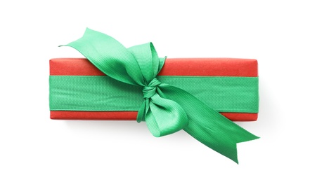 Photo of Christmas gift box decorated with green bow isolated on white, top view