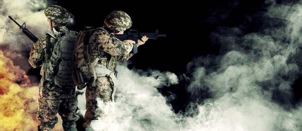 Image of Armed soldiers in smoke on black background, space for text