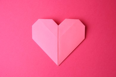 Photo of Paper heart on pink background, top view. Origami art