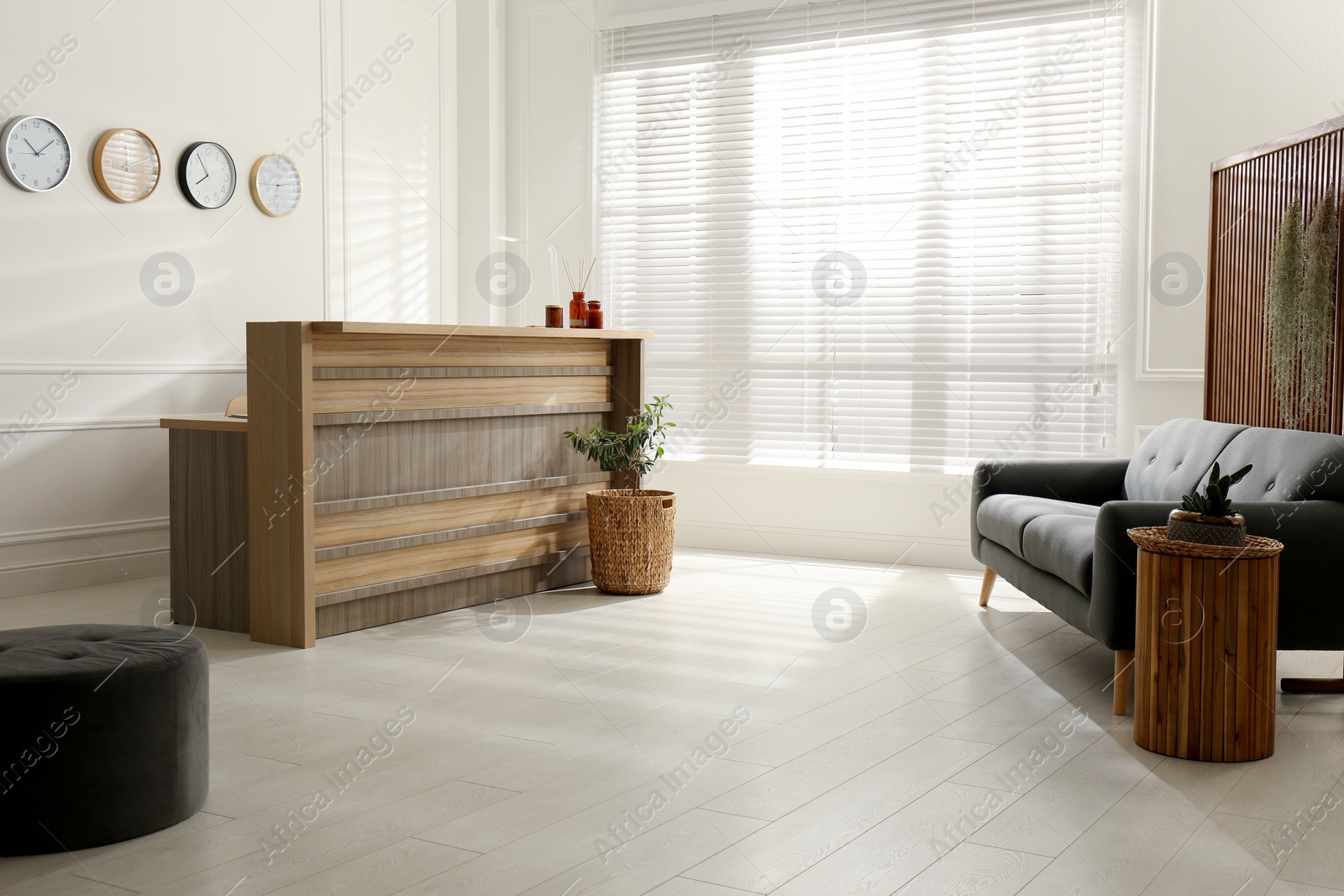 Photo of Hotel lobby interior with wooden reception desk. Stylish workplace