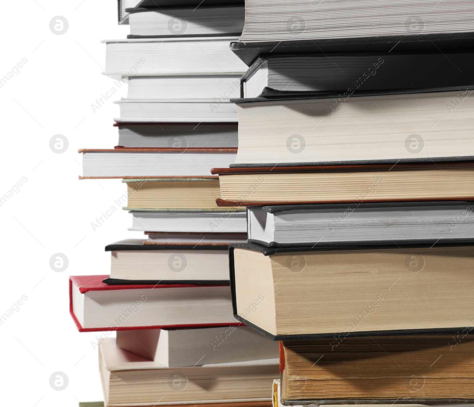 Photo of Stacks of many different books isolated on white