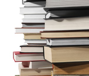 Photo of Stacks of many different books isolated on white