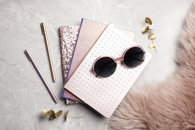 Flat lay composition with stylish notebooks on marble table