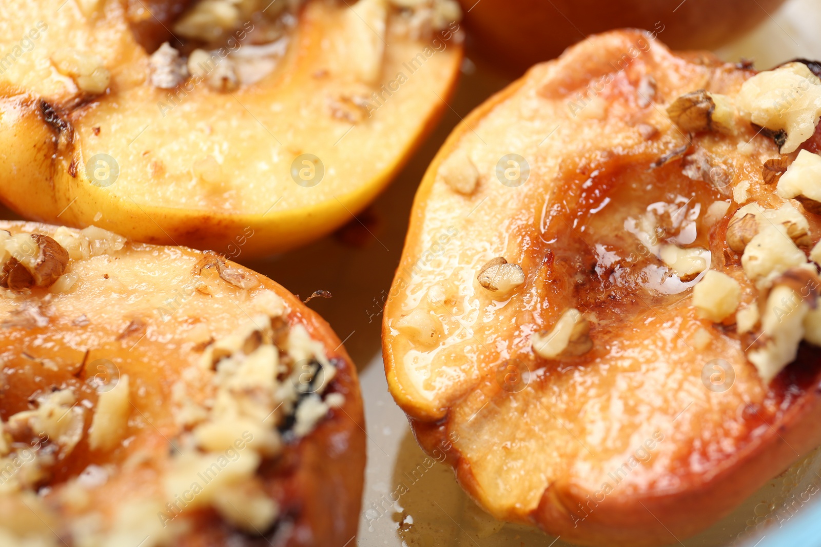 Photo of Delicious baked quinces with nuts and honey, closeup