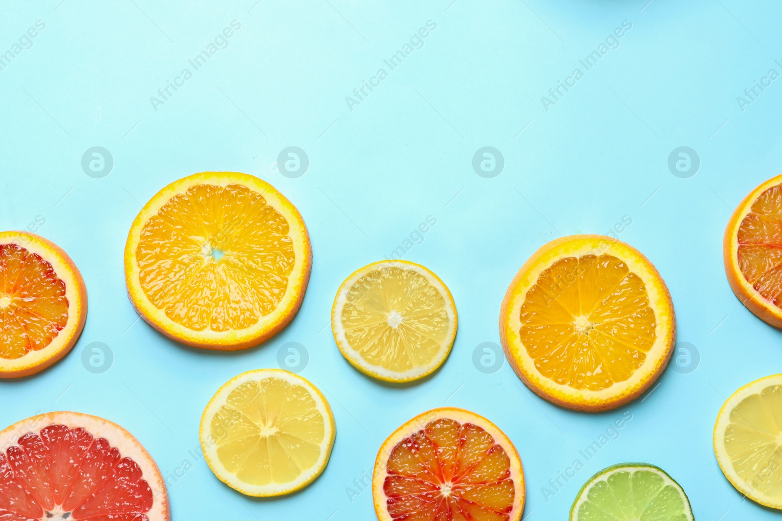 Photo of Different citrus fruits on color background, flat lay. Space for text