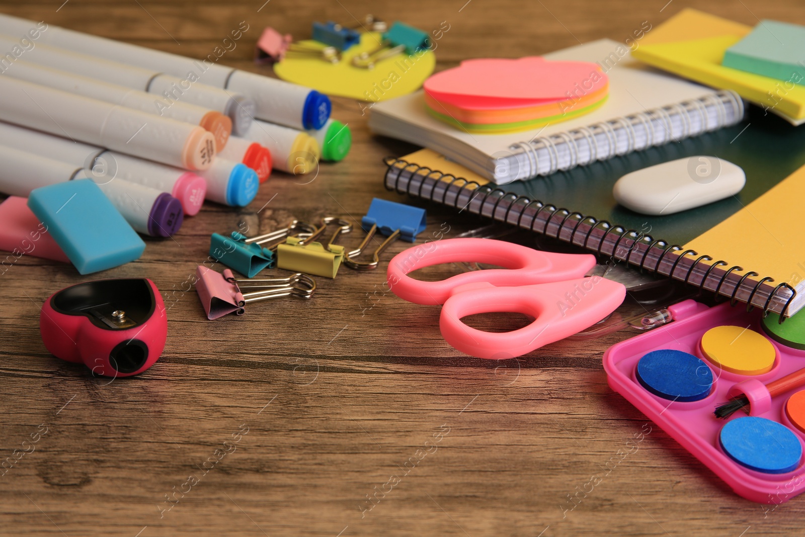 Photo of Many different school stationery on wooden table, closeup. Back to school