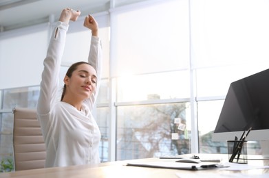 Young woman relaxing in office chair at workplace