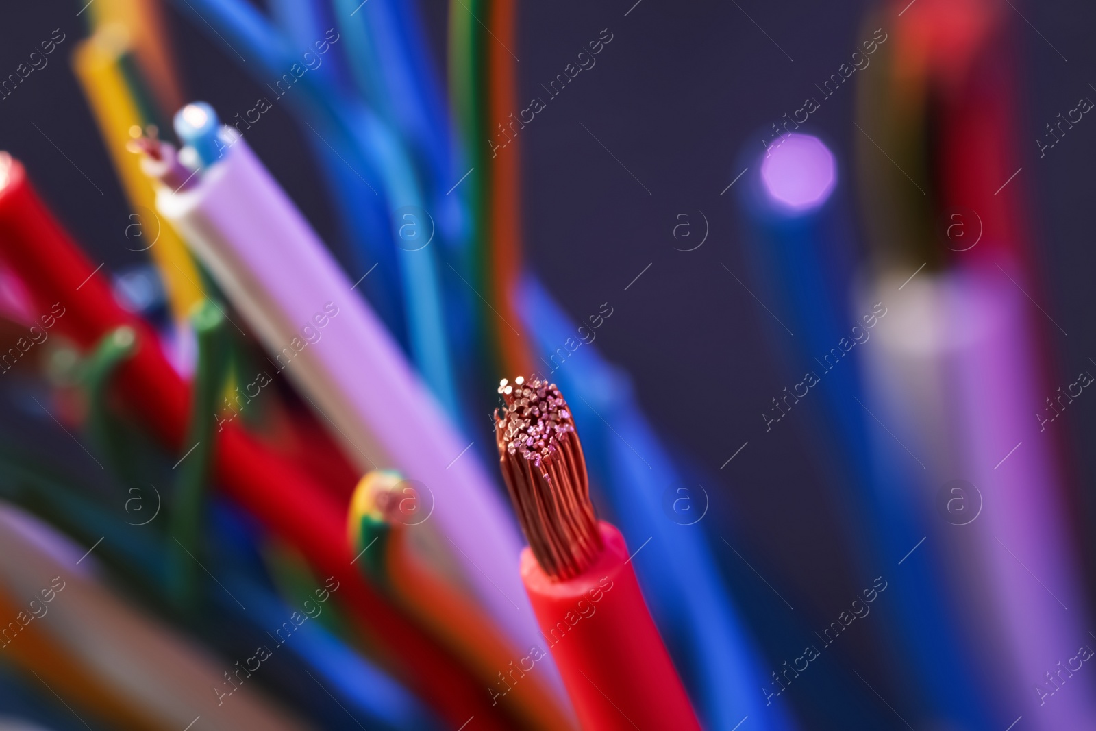 Photo of Colorful cables on blurred background, closeup. Electrician's supply