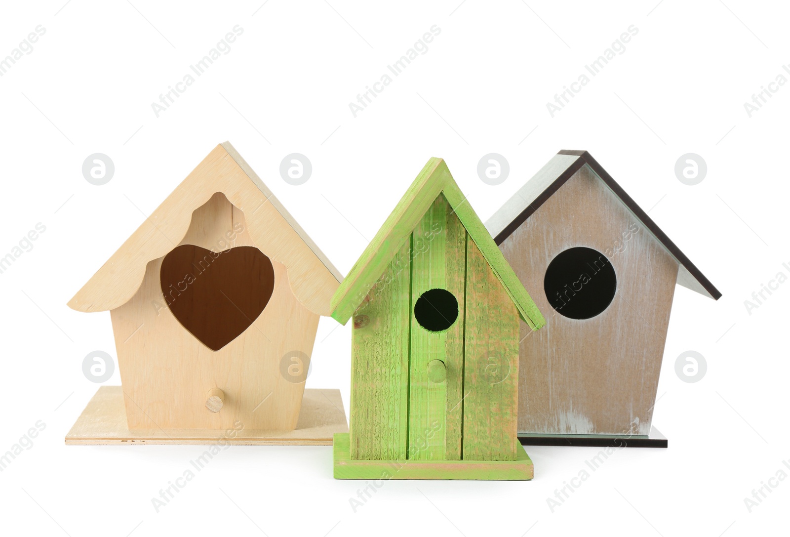 Photo of Three different bird houses on white background