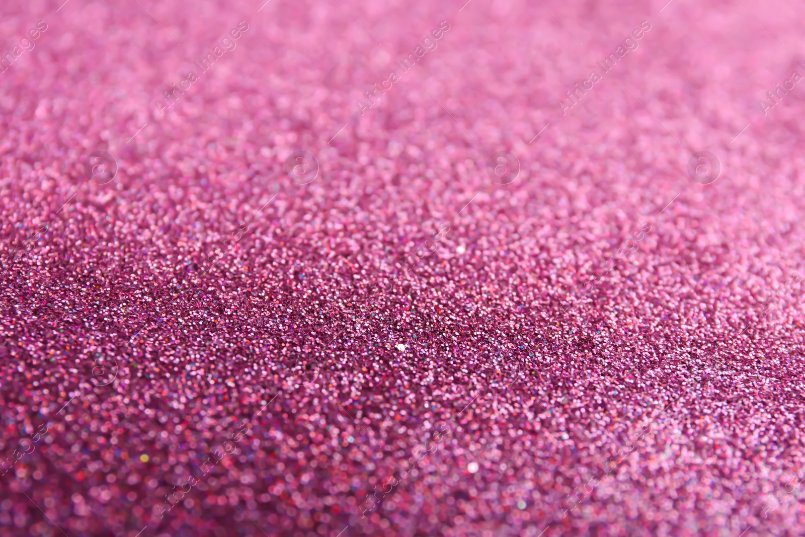 Photo of Closeup view of sparkling pink glitter background