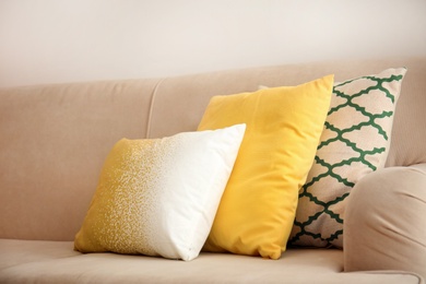 Different soft pillows on sofa in room