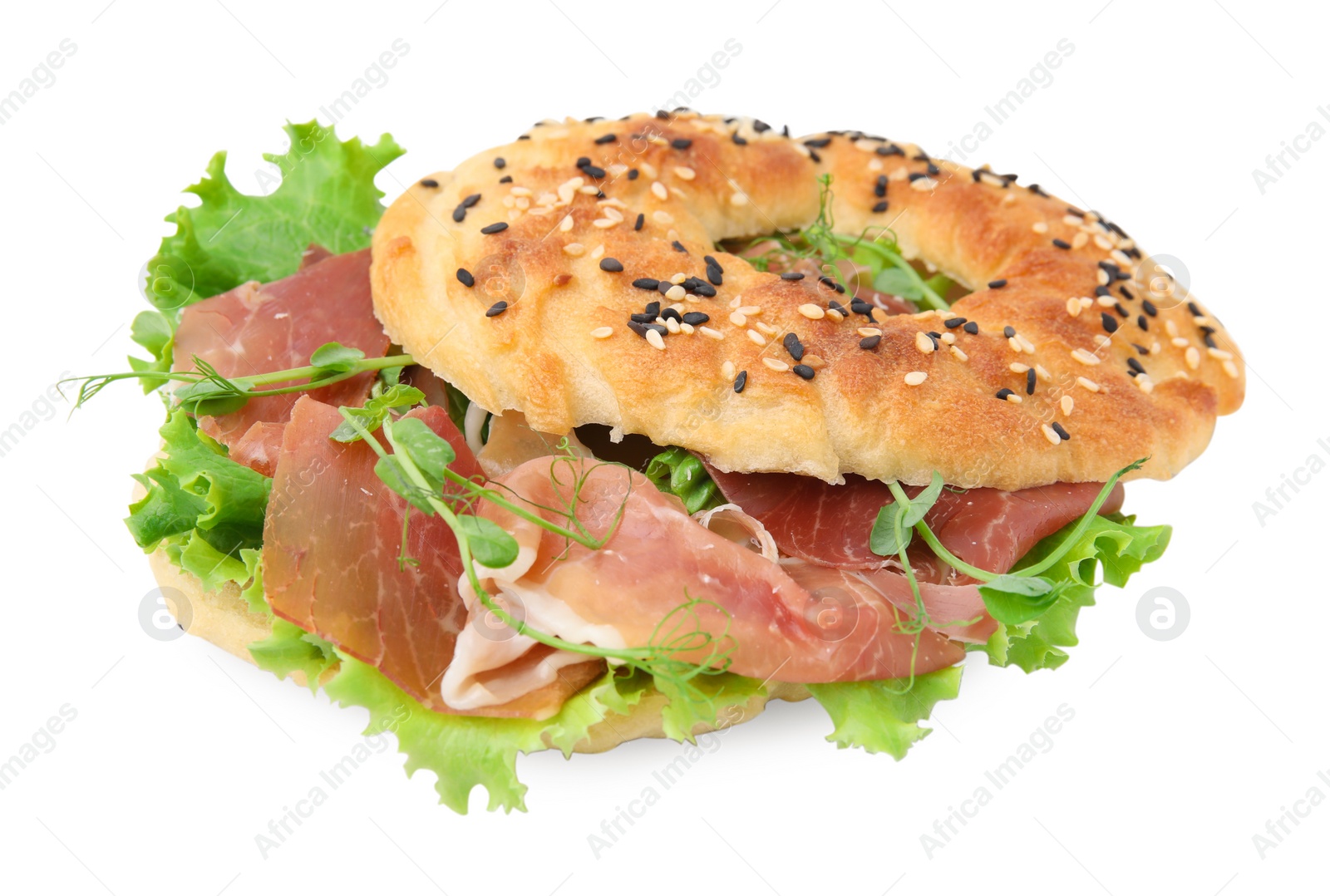 Photo of Tasty bagel with cured ham and lettuce isolated on white