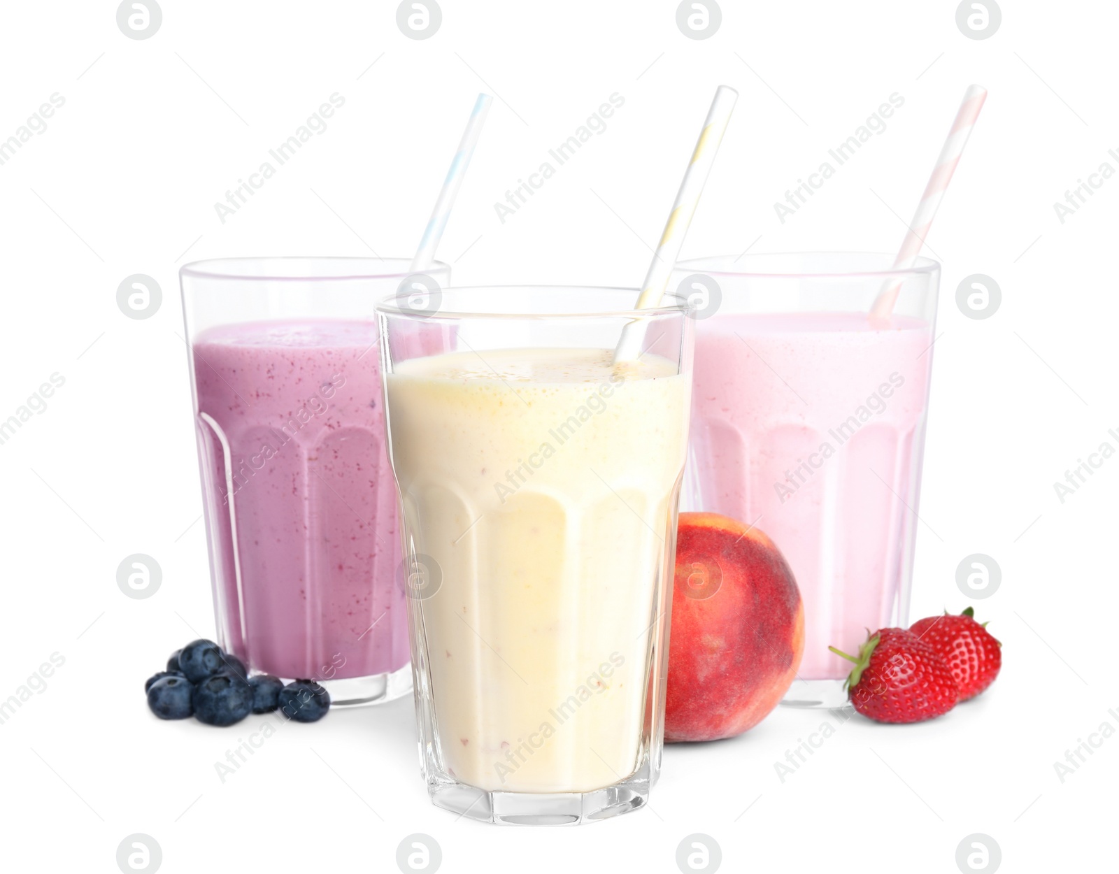 Photo of Different tasty milk shakes and fruits isolated on white