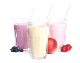Photo of Different tasty milk shakes and fruits isolated on white