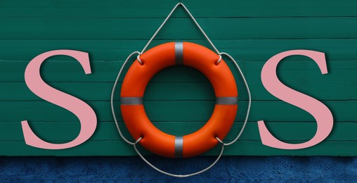 Image of SOS message made from lifebuoy and pink letters on green wooden board. Banner design