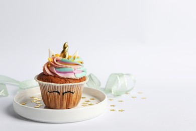 Photo of Cute sweet unicorn cupcake on white background, space for text