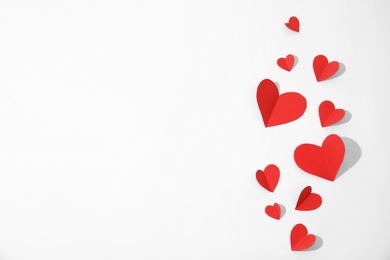 Photo of Small paper hearts on white background