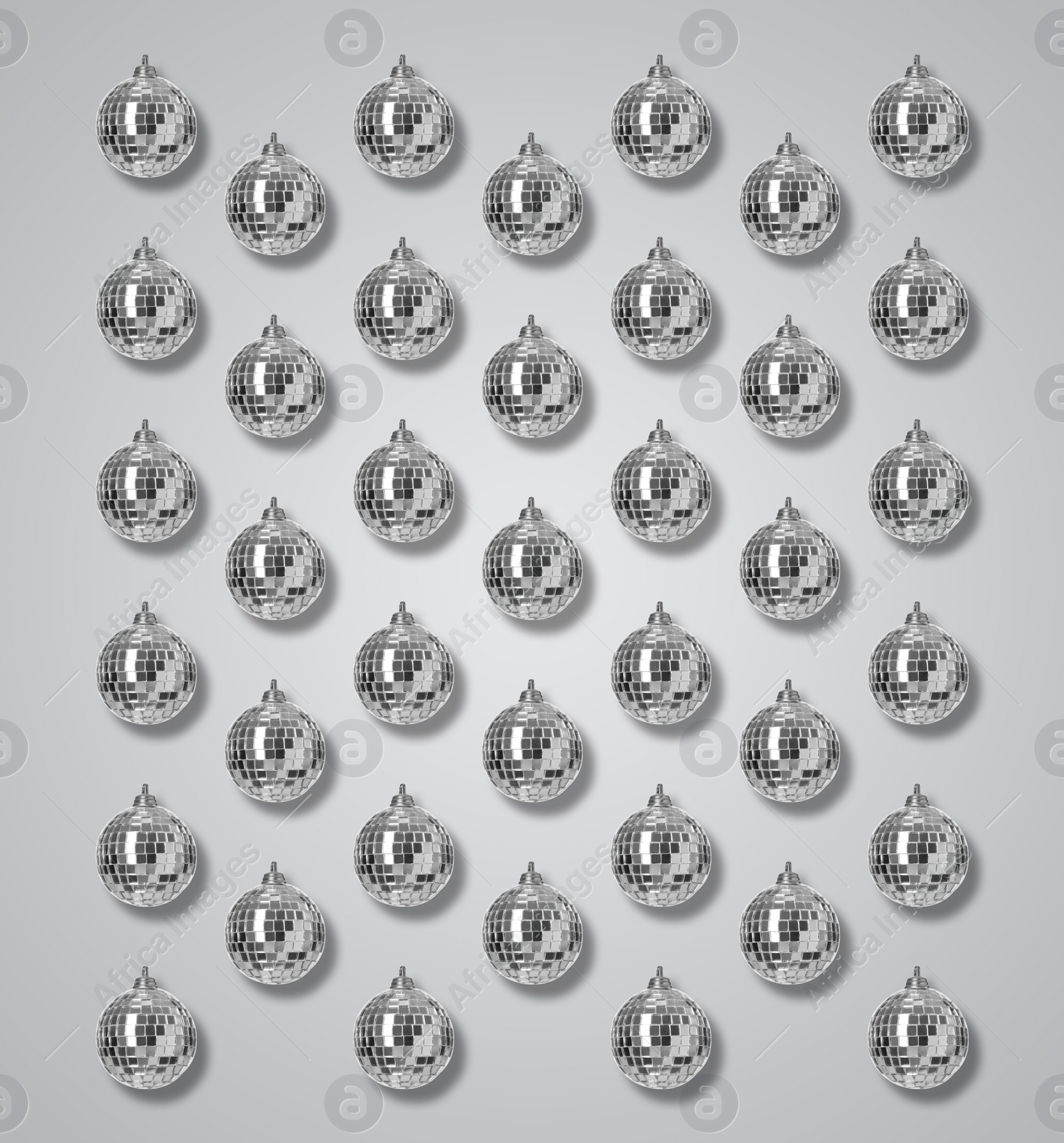 Image of Many shiny disco balls on grey background, flat lay