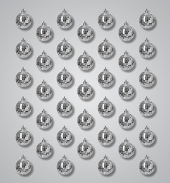 Many shiny disco balls on grey background, flat lay