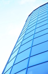 Photo of Modern office building with tinted windows against blue sky