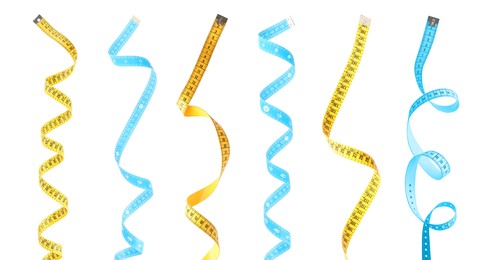 Image of Set with different measuring tapes on white background