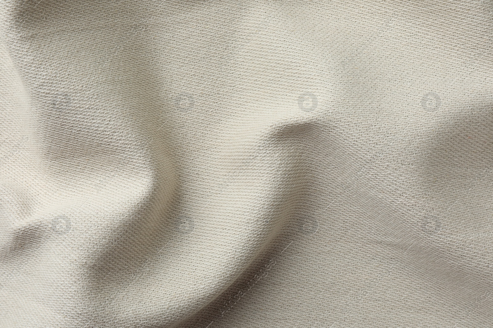 Photo of Texture of beige crumpled fabric as background, top view