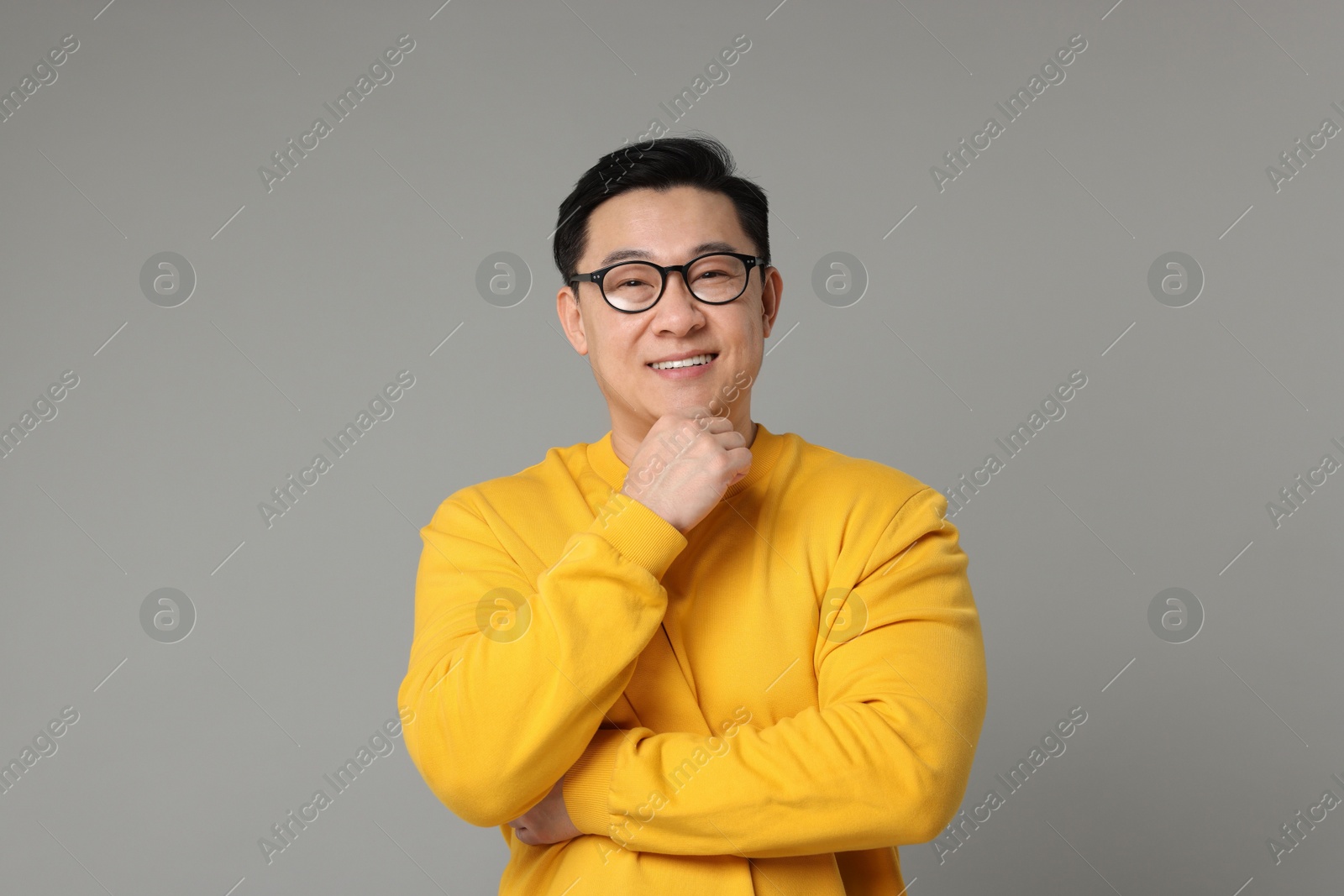 Photo of Portrait of happy man on grey background