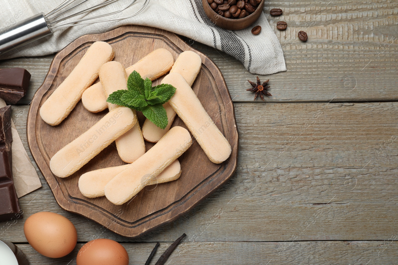 Photo of Flat lay composition with tiramisu ingredients on wooden table, space for text