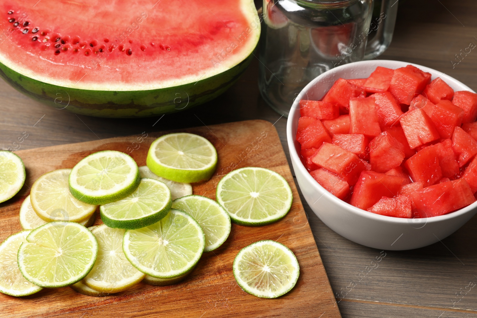 Photo of Fresh ingredients for making watermelon drink with lime on wooden table