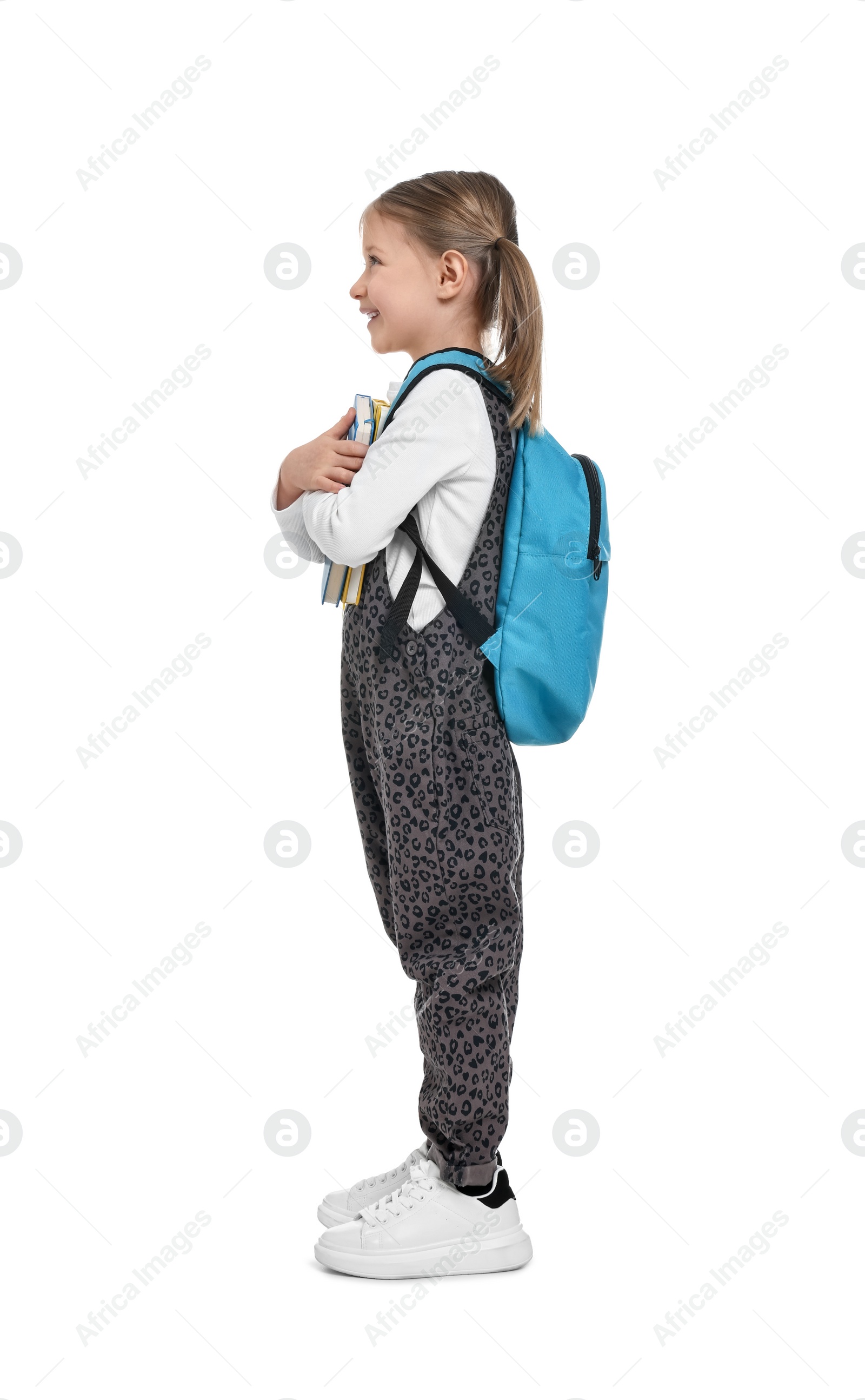 Photo of Cute schoolgirl with books on white background