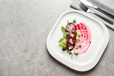 Photo of Plate with delicious beet salad on grey background, top view