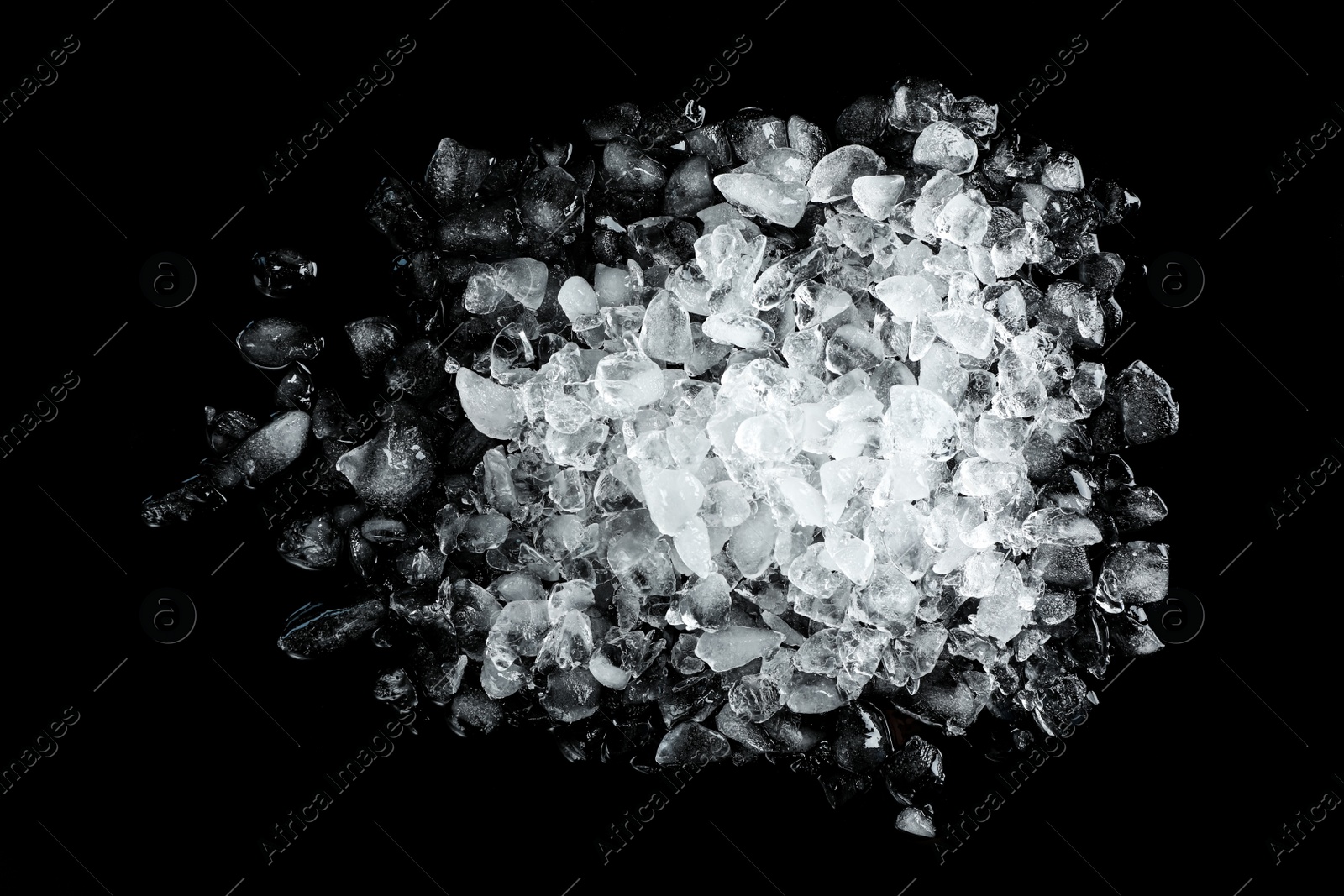 Photo of Heap of crushed ice on black table, top view