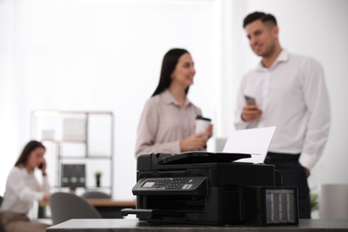 New modern printer on table in office. Space for text