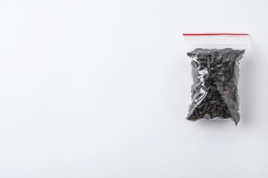 Photo of Plastic bag with spice on white background, top view