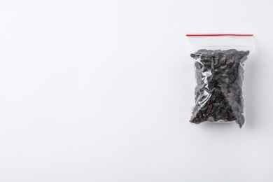 Plastic bag with spice on white background, top view