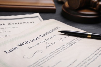 Photo of Last will and testament with pen on grey table, closeup